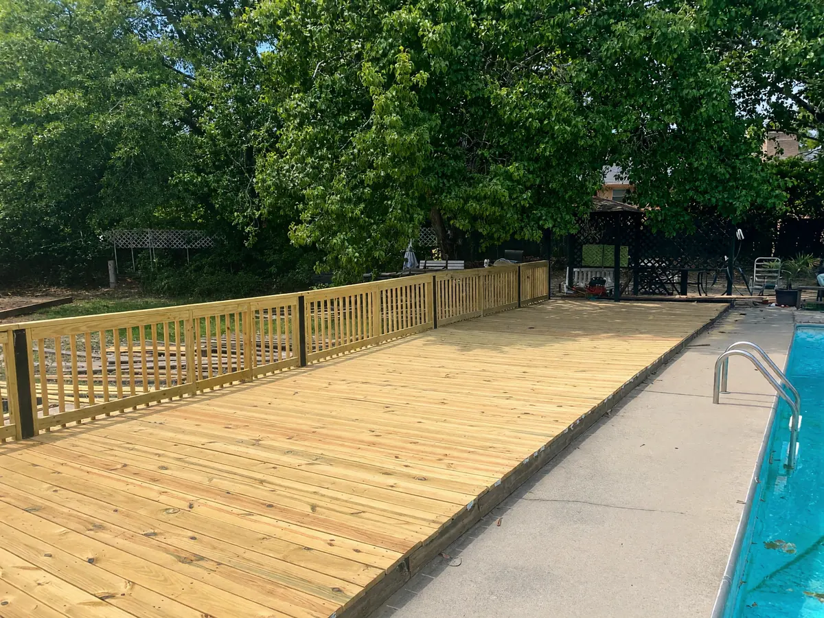 New wood deck beside a backyard pool