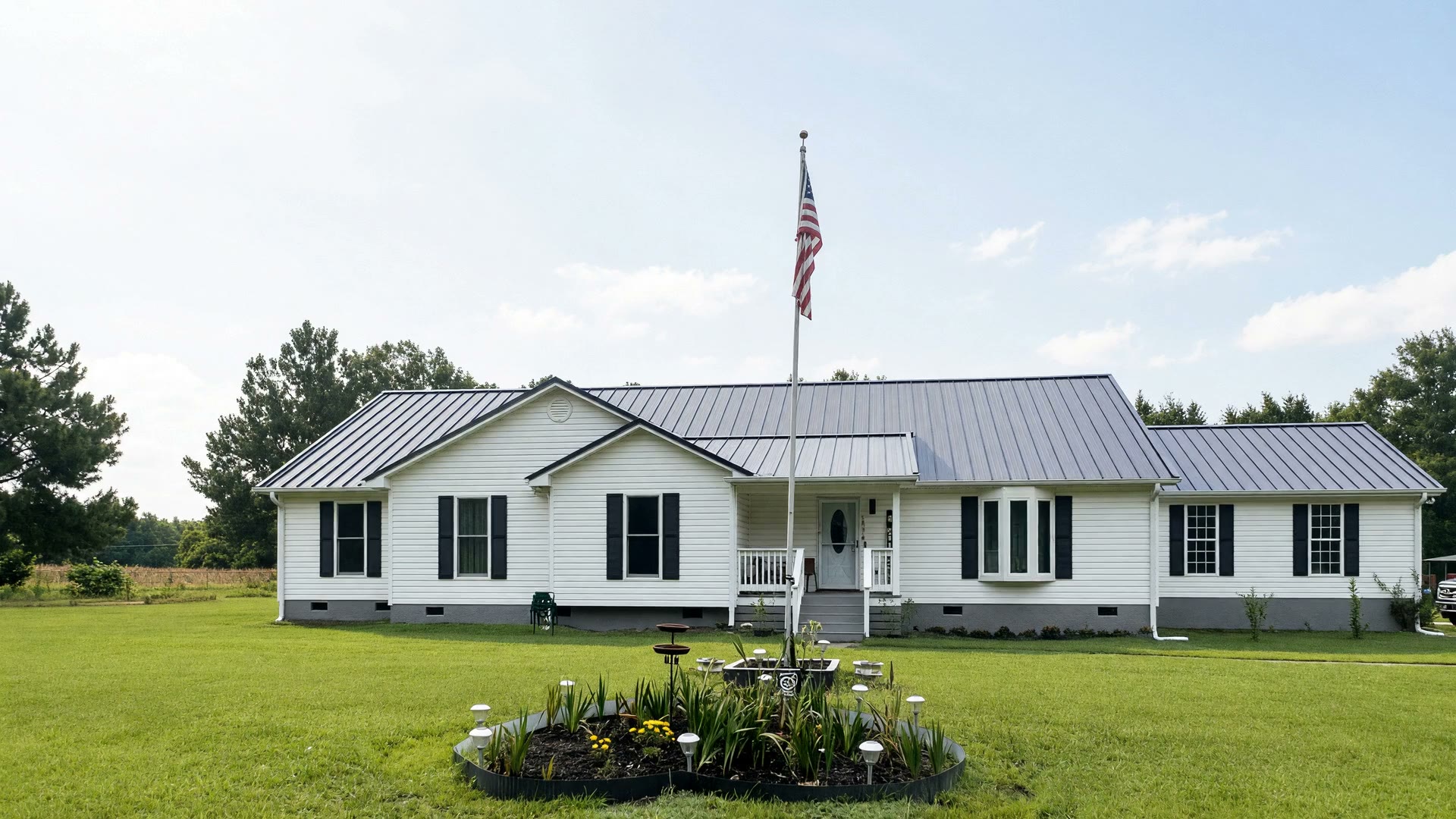 A white Midlands ranch under a new dark standing-seam metal roof