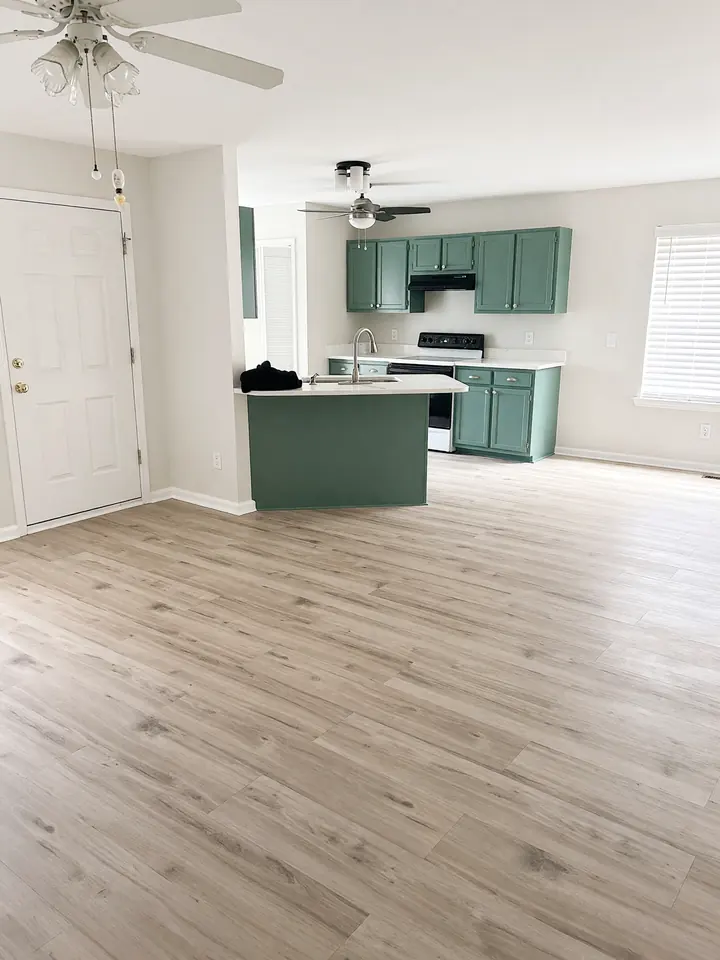 Kitchen with teal cabinets and new LVP flooring